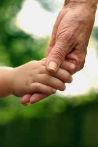 This picture of an adult hand holding a child’s hand represents the Friends help.